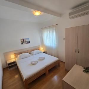 a bedroom with a bed with two towels on it at Pansion Bonaca in Srima +32 photos