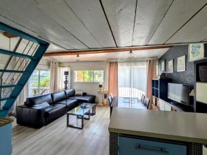 a living room with a couch and a table at Tiny house - Drap, France in Drap