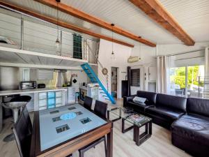 a living room with a couch and a table at Tiny house - Drap, France in Drap