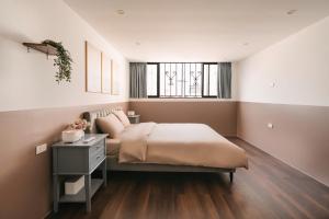 a bedroom with a large bed and a window at Morden Apt 6Br Old Quater in Hanoi