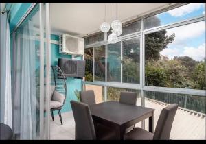 a screened in porch with a table and chairs at 94 Camarque Umdloti in Umdloti