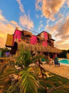 a resort with a building with a swimming pool at Mojarra Beach Casa Privada-Santa Veronica in Salina de Rey