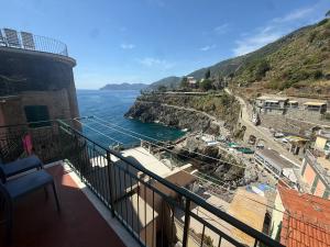 a balcony of a building with a view of the ocean at Mare Mosso 2 in Manarola
