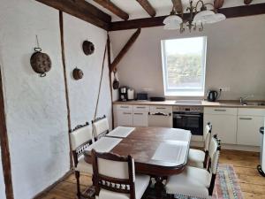 a kitchen with a wooden table and a table and chairs at Wunderschönes Winzerhaus Schenk in Neef +16 photos