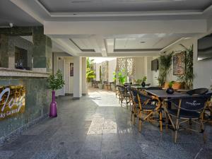 a dining room with tables and chairs and a fireplace at Panorama Ramsis Hotel & Cafe in Cairo