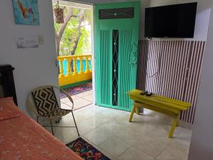 a room with a green door and a table and a bench at Playa Zen Rodadero in Rodadero