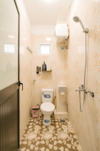 a small bathroom with a toilet and a shower at Morden Apt 6Br Old Quater in Hanoi
