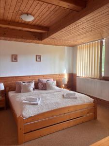 a bedroom with a large wooden bed in a room at Pension Pretty in Harrachov