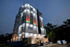 a tall building with lights on it at night at Hotel Aarnika Villa in New Town