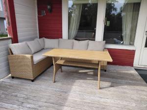 a couch and a coffee table on a porch at Artic home komfort in Tromsø