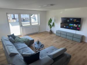 a living room with a couch and a flat screen tv at APARTMENT in Hambach in Hambach