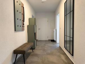 a hallway with a bench and some glass doors at APARTMENT in Hambach in Hambach