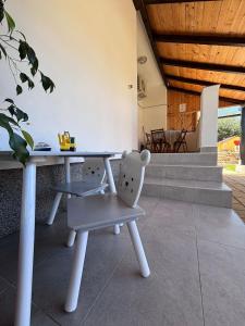 a table and a chair in a room at Apartmani Milka in Vrsi