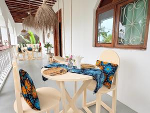 a dining room with a table and chairs at Bahari Paje Beach House in Paje