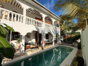 an external view of a house with a swimming pool at Bahari Paje Beach House in Paje