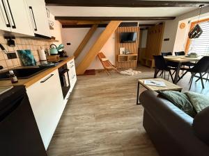 a kitchen and living room with a couch and a table at Holiday house Laura in Žiar +22 photos
