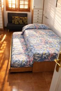a bed sitting in a room with a unintention at candelaria Quiet 2bedroom Apartment near the Sea FAST WIFI FAST WIFI in Candelaria