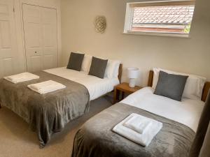 a room with two beds and a window at Number 15 in Norwich