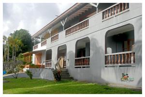 a white building with windows and a grass yard at Island View Estate in Kingstown