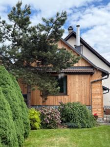 a house with a tree in front of it at Holiday house Laura in Žiar