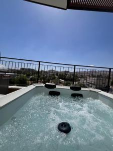 a jacuzzi tub with a view of the city at Cohav Sea View in Eilat