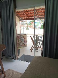 a room with a glass door leading to a patio at Flat Vista do Cruzeiro in Jacobina