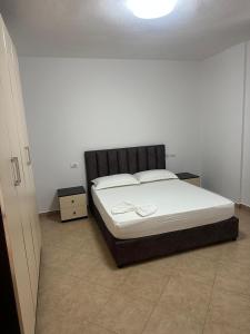 a bedroom with a bed with a black headboard at Villa Del Sol in Golem