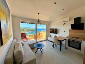 a living room with a couch and a table at Brand new Big Blue in Jelsa