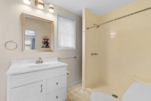 a white bathroom with a sink and a shower at The Brick House Georgetown in Georgetown +45 photos