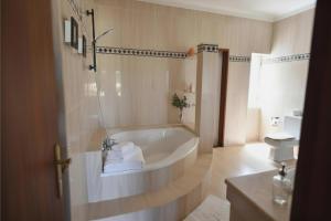 a bathroom with a bath tub and a toilet at Casa do Sol Wellness Villa in Óbidos +67 photos