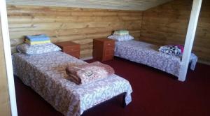 a room with three beds in a log cabin at Апартаменти Аліканте in Zatoka