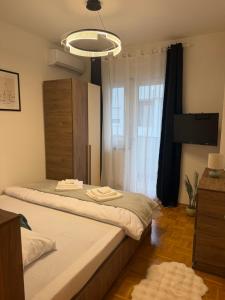 two beds in a room with a window at Premium Apartment in Peje