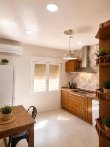a kitchen with a table and a refrigerator at CasaConchaGuadamur in Guadamur
