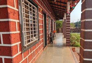 an empty hallway of a brick building with windows at Samarpit Guest House in Devgarh