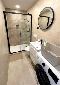 a bathroom with a shower sink and a washing machine at Brand new Big Blue in Jelsa +10 photos