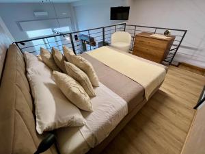 a bed with pillows on it in a room at Loft43 in Trani