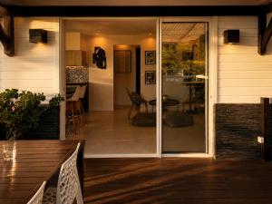 a porch with sliding glass doors on a house at Résidence Nakiya in Sainte-Marie