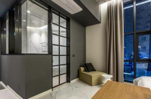 a bedroom with a desk and a chair and a window at Brown Dot Hotel Ulsan Samsan in Ulsan +78 photos