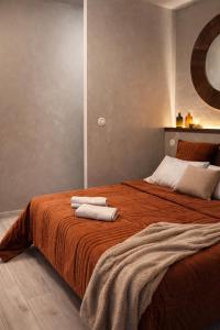a bedroom with a bed with two towels on it at Résidence Nakiya in Sainte-Marie