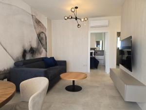 a living room with a blue couch and a table at Nautico apartment with swimming pool in Opatija