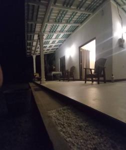 a room with chairs and a table in a building at Amith Villa in Koggala