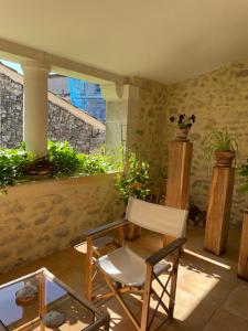 a white chair sitting in a room with a window at la capelette in Céreste