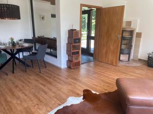 a living room with a wooden floor and a table at Allgäu Bungalow GLOW in Isny im Allgäu +33 photos