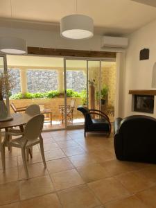 a living room with chairs and a table at la capelette in Céreste