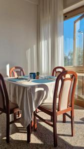 a dining room table with four chairs and a tablecloth at Hotel Nemo in Misano Adriatico