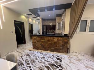 a living room with a marble floor and a kitchen at Nile palace apartment in Luxor
