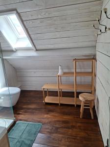 a attic bathroom with a skylight and a bench and a sink at Casa Ysermonde- Barkas 8 in Nieuwpoort +9 photos