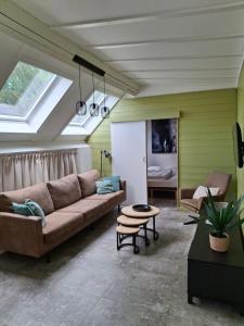 a living room with a couch and a table at Casa Ysermonde- Barkas 8 in Nieuwpoort
