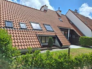 a house with a red tiled roof at Casa Ysermonde- Barkas 8 in Nieuwpoort