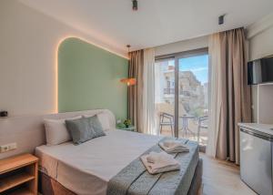 a bedroom with a bed and a balcony at The Wave in Limenaria